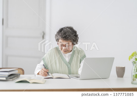Senior woman doing desk work Senior woman doing desk work 137771085