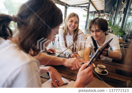 Data, information on the document. Group of young friends are in the cafe restaurant Data, information on the document. Group of young friends are in the cafe restaurant 137771523
