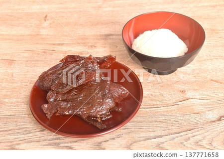 salty and sweet dry fried slice beef meat fermenting in sesame oil and pepper on plate eat couple sticky rice 137771658