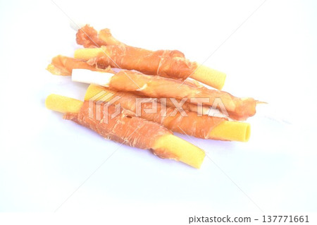 dog snack crunchy stick made from cow leather and bone wrapped chicken meat on white background 137771661