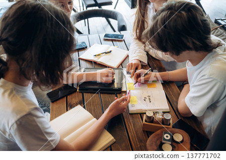 Document with plan, education or business conception. Group of young friends are in the cafe restaurant Document with plan, education or business conception. Group of young friends are in the cafe restaurant 137771702