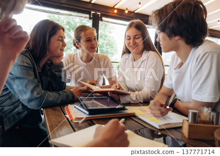 Cheerful facial expression, having fun. Group of young friends are in the cafe restaurant Cheerful facial expression, having fun. Group of young friends are in the cafe restaurant 137771714