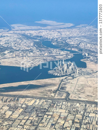 A view of the Dubai cityscape from inside the plane shortly after takeoff from Dubai Airport. A view of the Dubai cityscape from inside the plane shortly after takeoff from Dubai Airport. 137771803
