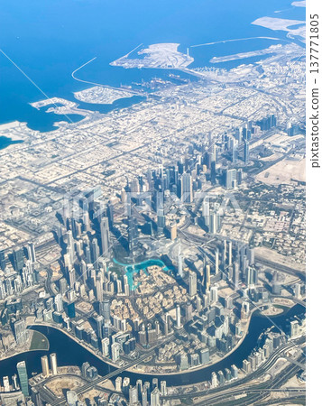 A view of the Dubai cityscape from inside the plane shortly after takeoff from Dubai Airport. A view of the Dubai cityscape from inside the plane shortly after takeoff from Dubai Airport. 137771805
