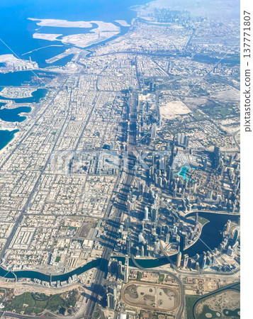 A view of the Dubai cityscape from inside the plane shortly after takeoff from Dubai Airport. 137771807