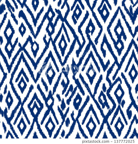 Seamless ikat geometric pattern creating textile design. Traditional blue chevron ikat pattern forming a seamless repeating background texture Seamless ikat geometric pattern creating textile design. Traditional blue chevron ikat pattern forming a seamless repeating background texture 137772025