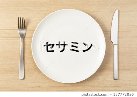 A plate and cutlery with "Sesamin" written on it. A plate and cutlery with "Sesamin" written on it. 137772056