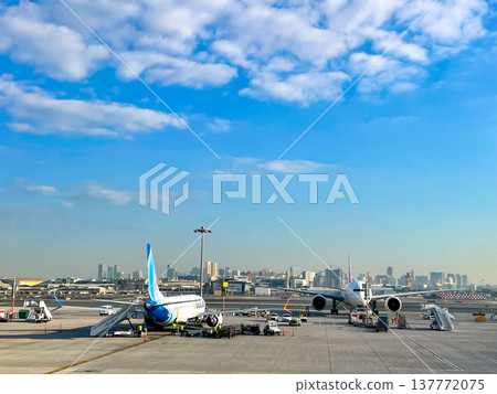 A FlyDubai B737 preparing for departure at Dubai Airport. A FlyDubai B737 preparing for departure at Dubai Airport. 137772075