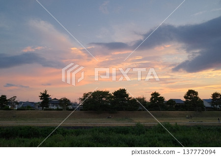 Clouds and soft sky tinged with the colors of a summer evening. Clouds and soft sky tinged with the colors of a summer evening. 137772094