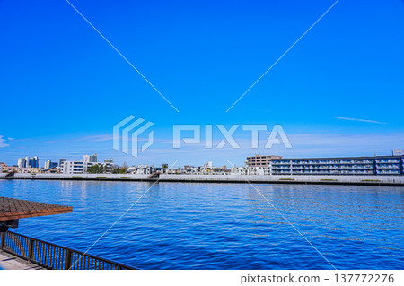Apartment buildings across the Nakagawa River under a clear blue sky. Apartment buildings across the Nakagawa River under a clear blue sky. 137772276