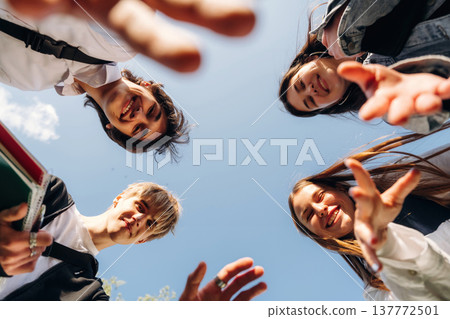 View from below of young friends against the sky View from below of young friends against the sky 137772501