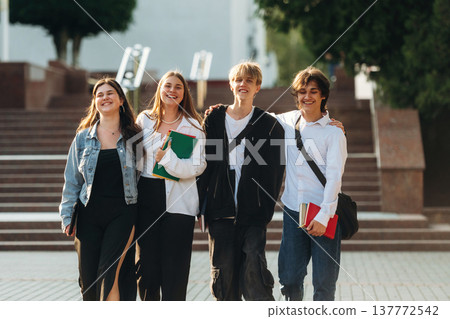 Having a break, walking. Group of students are near university together Having a break, walking. Group of students are near university together 137772542