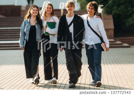 Having a break, walking. Group of students are near university together Having a break, walking. Group of students are near university together 137772543