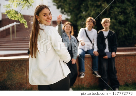 Posing, standing. Group of students are near university together Posing, standing. Group of students are near university together 137772773