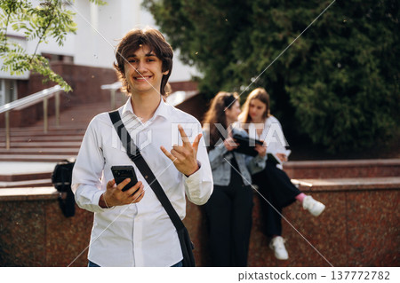 White shirt, positive facial expression. Group of students are near university together 137772782