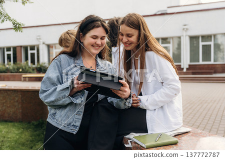Feeling good, smiling. Group of students are near university together Feeling good, smiling. Group of students are near university together 137772787