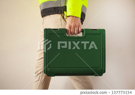 Male hand with Tool Kit Suitcase. Portable Hardware Combination Tool Set for Repair and Maintenance Male hand with Tool Kit Suitcase. Portable Hardware Combination Tool Set for Repair and Maintenance 137773154
