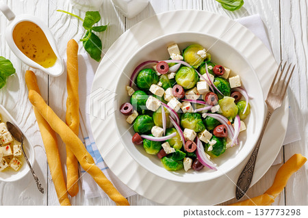 brussels sprouts salad with feta, olives in bowl brussels sprouts salad with feta, olives in bowl 137773298