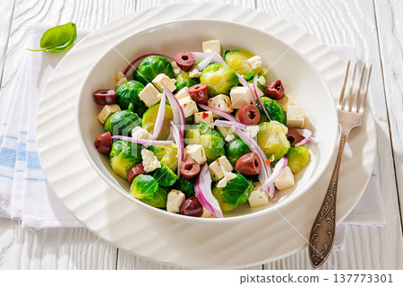 brussels sprouts salad with feta, olives in bowl brussels sprouts salad with feta, olives in bowl 137773301