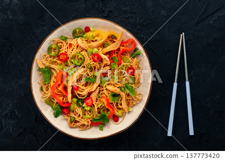 Chow Mein noodles with chicken and vegetables, overhead flat lay shot 137773420