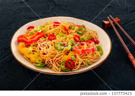 Hakka noodles with vegetables, peppers and green onions, with chopsticks Hakka noodles with vegetables, peppers and green onions, with chopsticks 137773423