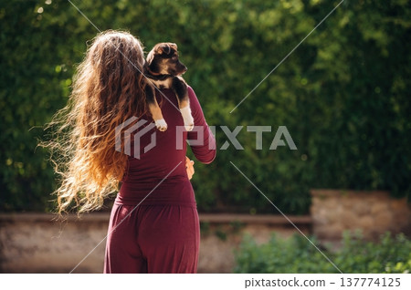 Love and care conception. Holding animal. Woman is with cute dog outdoors Love and care conception. Holding animal. Woman is with cute dog outdoors 137774125