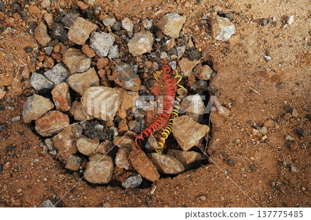 time bomb placed on a dusty mud road time bomb placed on a dusty mud road 137775485