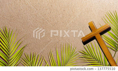 A wooden cross sits among green palm branches on a textured sandy background, representing Palm Sunday and the start of Holy Week in the Christian faith A wooden cross sits among green palm branches on a textured sandy background, representing Palm Sunday and the start of Holy Week in the Christian faith 137775510