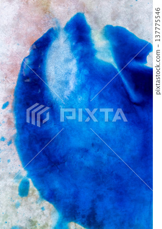A vibrant abstract composition featuring deep blue ink or watercolor wash on a textured, grainy paper surface with subtle organic color bleeds and splatters 137775546