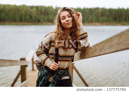 Attractive young woman enjoying fresh air on the lake. Travel, Hiking, nature 137775790