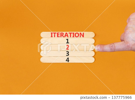 Time to iteration 2 symbol. Concept word Iteration 1 2 3 4 on beautiful wooden sticks. Businessman's hand. Beautiful orange background. Business planning and time to iteration 2 concept. Copy space. Time to iteration 2 symbol. Concept word Iteration 1 2 3 4 on beautiful wooden sticks. Businessman's hand. Beautiful orange background. Business planning and time to iteration 2 concept. Copy space. 137775966