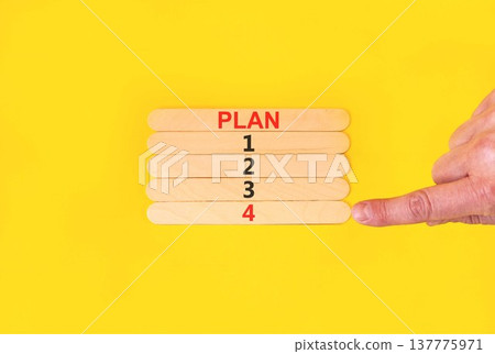 Time to plan 4 symbol. Concept word Plan 1 2 3 4 on beautiful wooden sticks. Businessman's hand. Beautiful yellow background. Business planning and time to plan 4 concept. Copy space. Time to plan 4 symbol. Concept word Plan 1 2 3 4 on beautiful wooden sticks. Businessman's hand. Beautiful yellow background. Business planning and time to plan 4 concept. Copy space. 137775971