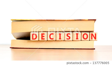 Decision word symbol. Concept word Decision on beautiful wooden blocks in beautiful book. Beautiful wooden table white background. Business support help decision word concept. Copy space. Decision word symbol. Concept word Decision on beautiful wooden blocks in beautiful book. Beautiful wooden table white background. Business support help decision word concept. Copy space. 137776005