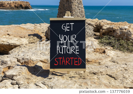 Get your future started symbol. Concept words Get your future started on beautiful black blackboard. Beautiful stone and blue sea sky background. Business get your future started concept. Copy space. 137776039
