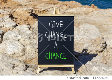 Give change a chance symbol. Concept words phrase Give change a chance on beautiful black blackboard. Beautiful stone blue sea sky background. Business Give change a chance concept. Copy space. Give change a chance symbol. Concept words phrase Give change a chance on beautiful black blackboard. Beautiful stone blue sea sky background. Business Give change a chance concept. Copy space. 137776040