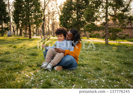 Loving mother and son enjoying time together in park Loving mother and son enjoying time together in park 137776245
