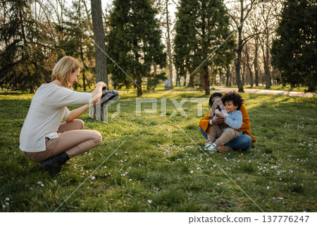 Mother and child posing for outdoor professional photography session Mother and child posing for outdoor professional photography session 137776247