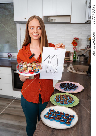Young woman rating delicious homemade truffles dessert in kitchen 137776355