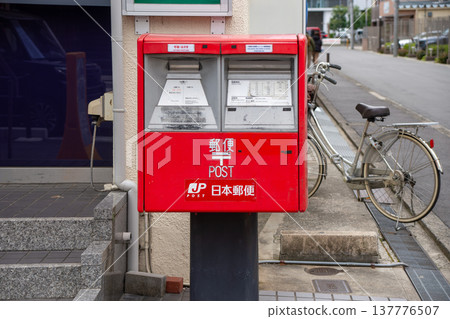 郵局旁邊有一個方形信箱。 137776507