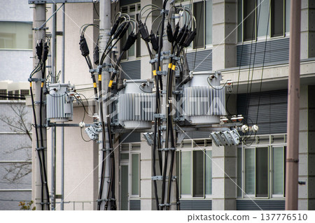 Pole-mounted transformer and electric wires on a utility pole Pole-mounted transformer and electric wires on a utility pole 137776510