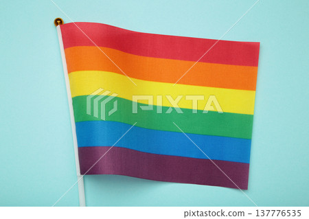 LGBT rainbow flag flat lay on blue background. LGBT rainbow flag flat lay on blue background. 137776535