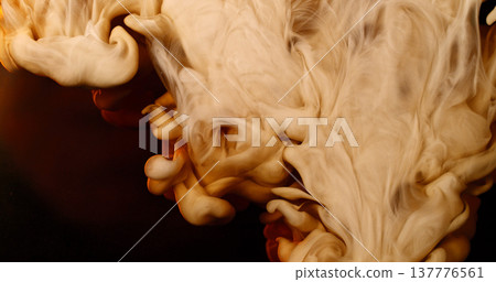 Abstract macro of milk mixing with coffee creating flowing creamy patterns and fluid shapes. Swirling liquid forms soft textures and organic motion, forming a dramatic beverage background. Abstract macro of milk mixing with coffee creating flowing creamy patterns and fluid shapes. Swirling liquid forms soft textures and organic motion, forming a dramatic beverage background. 137776561