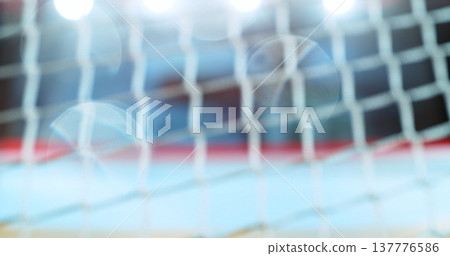 Abstract ice hockey background with a blurred goal net and arena lights. Soft focus and lens flare create a dynamic sports backdrop with copy space, ideal for text, branding, advertising or graphic 137776586