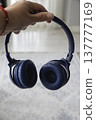 Close up of blue wireless headphones on the head 137777169