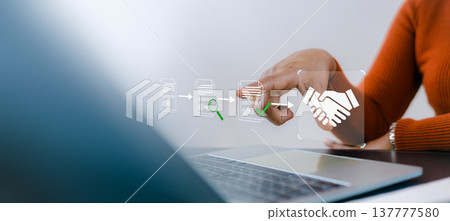 Businesswoman using laptop with digital workflow icons showing document processing and handshake. Concept of smart contract, automation, and document management system DMS in office. 137777580