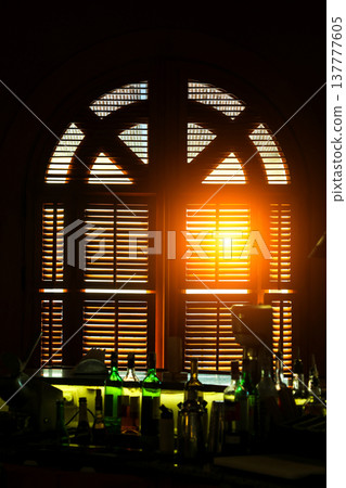 The first rays of sun illuminate the bar counter through the window 137777605