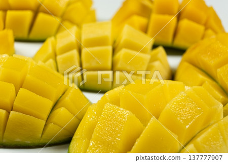Juicy mango halves with cube cut pattern. 137777907