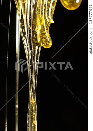 Creative honey swirl on black background. Creative honey swirl on black background. 137777931