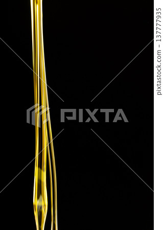Vertical Abstract Background Flow Of Unrefined Oil On Black Background, Space For Text, Macro Texture Vertical Abstract Background Flow Of Unrefined Oil On Black Background, Space For Text, Macro Texture 137777935