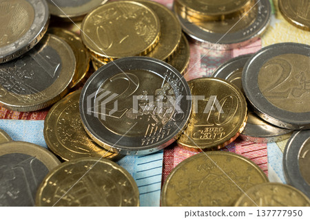 Close up of Euro coins on top of banknotes background. Close up of Euro coins on top of banknotes background. 137777950